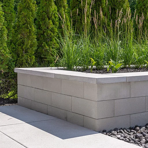 Smooth-finish Oaks Ortana raised planter wall with capped top